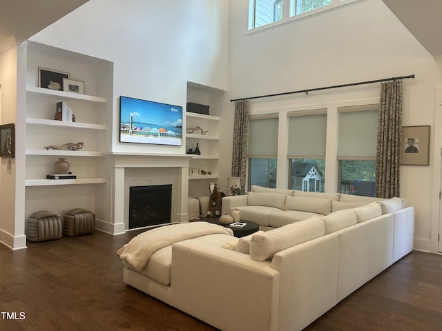 127 Sanderway Dr, Chapel Hill, NC 27516 - living room with a towering ceiling, dark wood-style floors, a fireplace, and built in features
