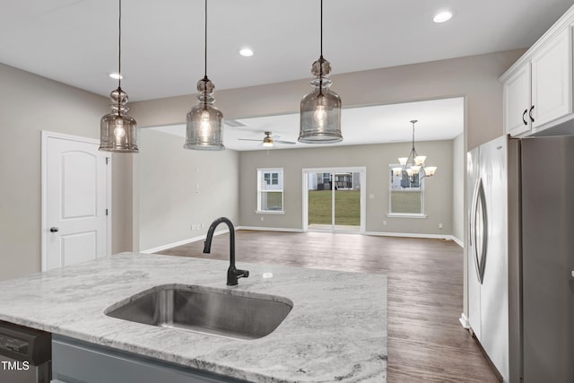 41 Willow Green Dr, Clayton, NC 27527 - kitchen with freestanding refrigerator, dishwashing machine, pendant lighting, ceiling fan with notable chandelier, and a sink