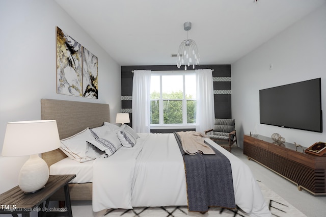 bedroom featuring an inviting chandelier and visible vents