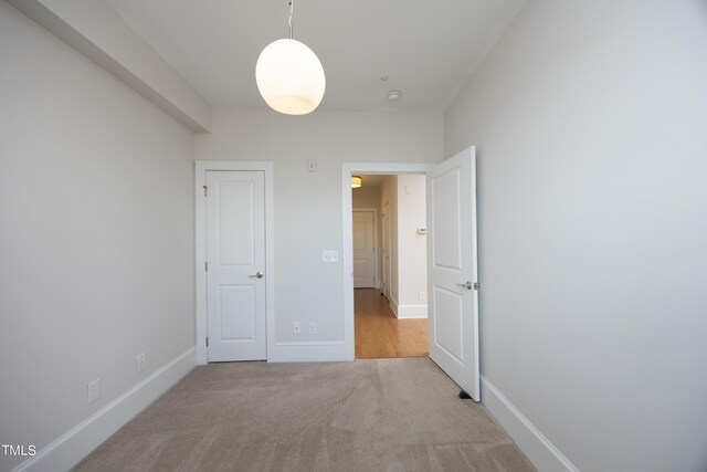 interior space with carpet and baseboards