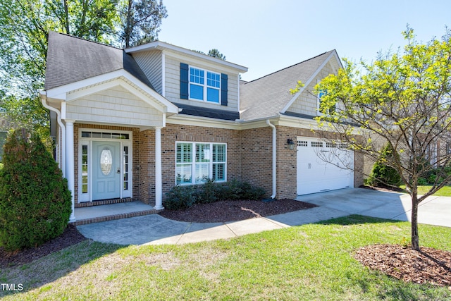 view of front facade with a front yard, an attached garage, brick siding, and driveway