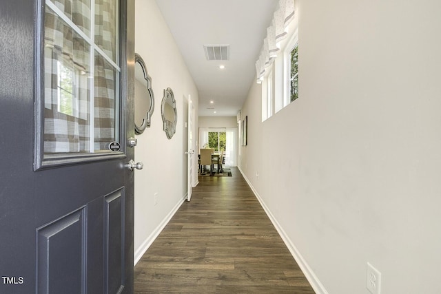 hallway with visible vents, baseboards, recessed lighting, and dark wood-style floors
