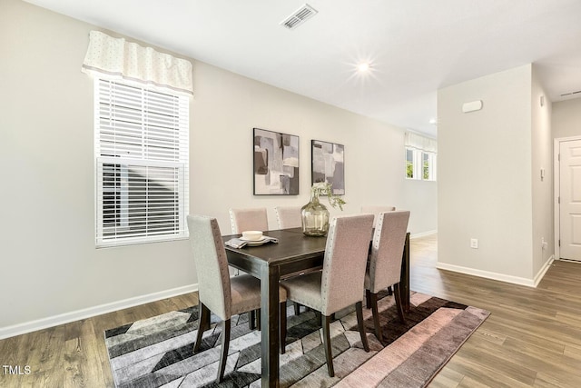 dining area featuring wood finished floors, baseboards, visible vents, and recessed lighting