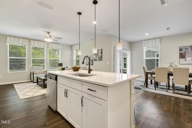 kitchen featuring stainless steel dishwasher, dark wood-style floors, a sink, and a ceiling fan