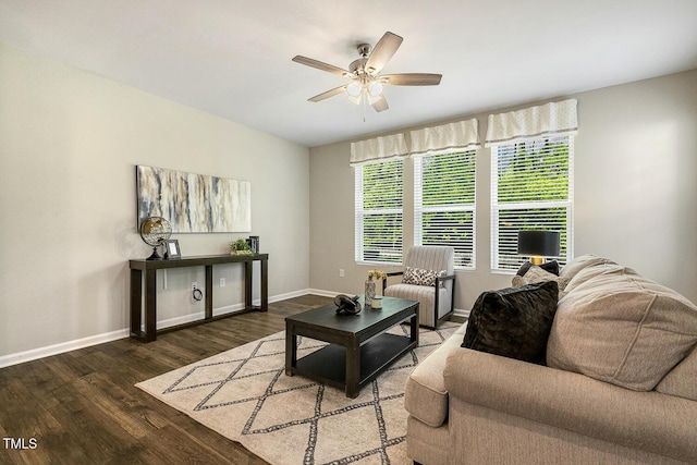 living area featuring baseboards, wood finished floors, and ceiling fan