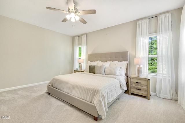bedroom featuring baseboards, a ceiling fan, and light colored carpet
