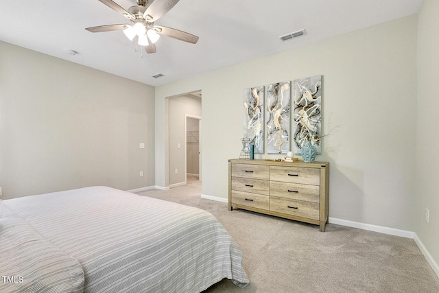 bedroom featuring visible vents, baseboards, a ceiling fan, and light colored carpet