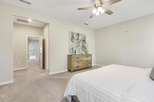 bedroom featuring visible vents, baseboards, and light carpet