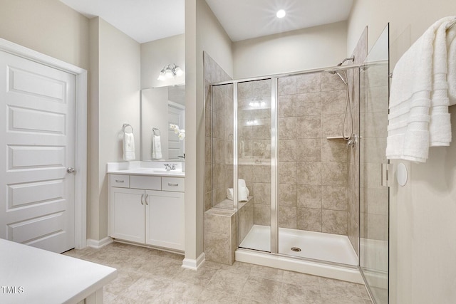 full bathroom with tile patterned floors, a stall shower, and vanity