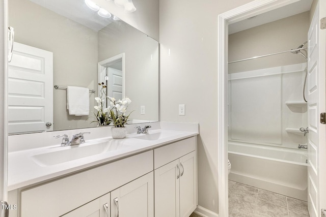 full bath featuring toilet, shower / tub combination, double vanity, and a sink