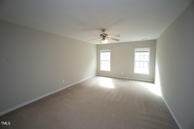 unfurnished room featuring ceiling fan, carpet, and baseboards