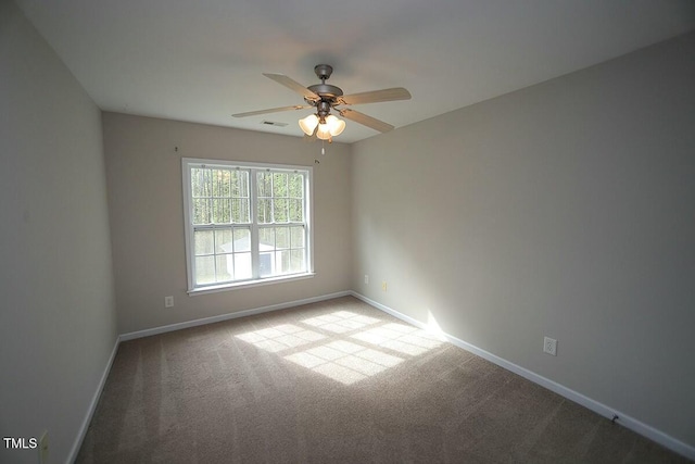 empty room with carpet floors, baseboards, and ceiling fan