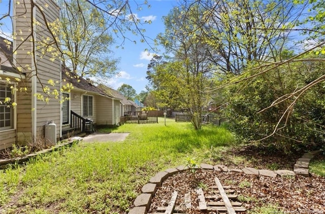 view of yard featuring entry steps and fence