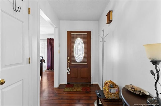 entryway featuring baseboards and dark wood finished floors