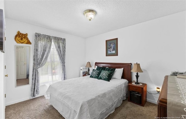 bedroom featuring a textured ceiling, carpet flooring, and baseboards