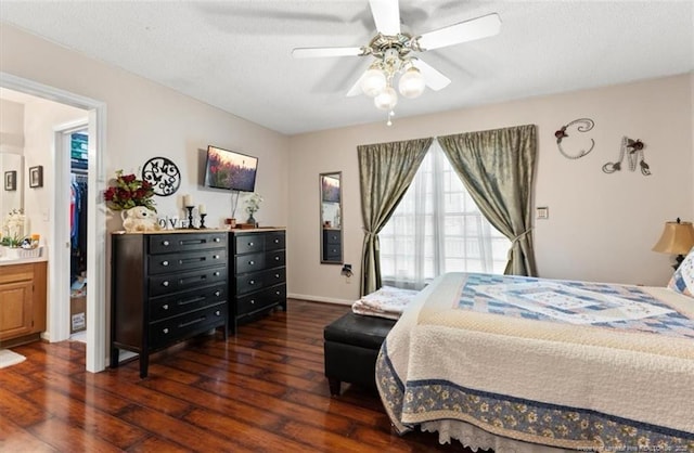 bedroom with ceiling fan, a textured ceiling, baseboards, and wood finished floors