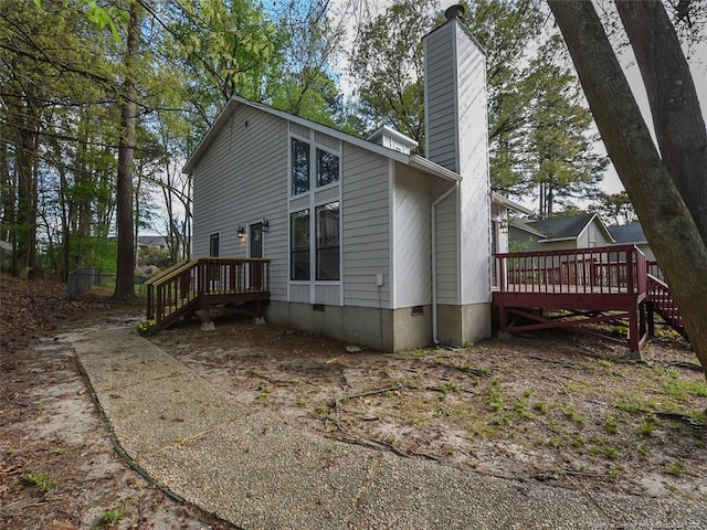 494 Wilder Dr, Fayetteville, NC 28314 - rear view of house featuring crawl space, a chimney, and a wooden deck