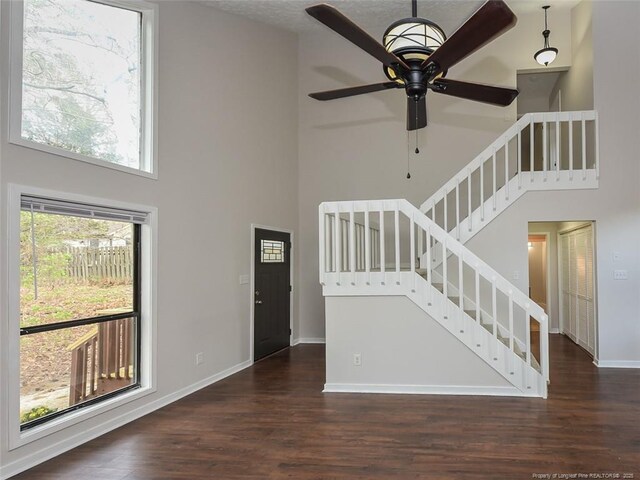 494 Wilder Dr, Fayetteville, NC 28314 - unfurnished living room with stairway, a high ceiling, and wood finished floors