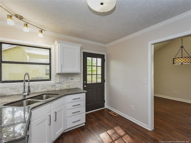 494 Wilder Dr, Fayetteville, NC 28314 - kitchen with ornamental molding, a textured ceiling, dark stone counters, dark wood finished floors, and a sink