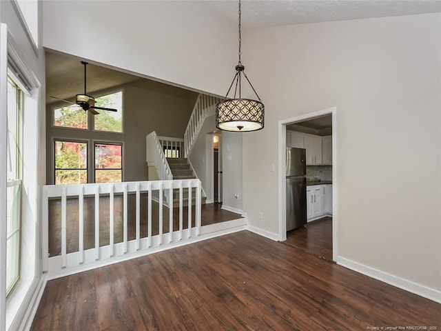 494 Wilder Dr, Fayetteville, NC 28314 - unfurnished dining area featuring dark wood finished floors, high vaulted ceiling, baseboards, and a ceiling fan