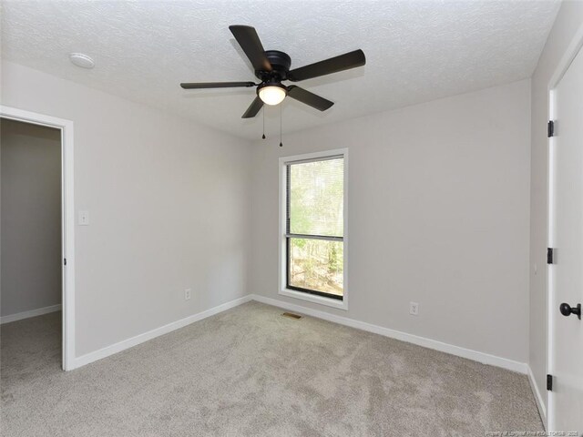 494 Wilder Dr, Fayetteville, NC 28314 - empty room featuring carpet floors, ceiling fan, baseboards, and a textured ceiling