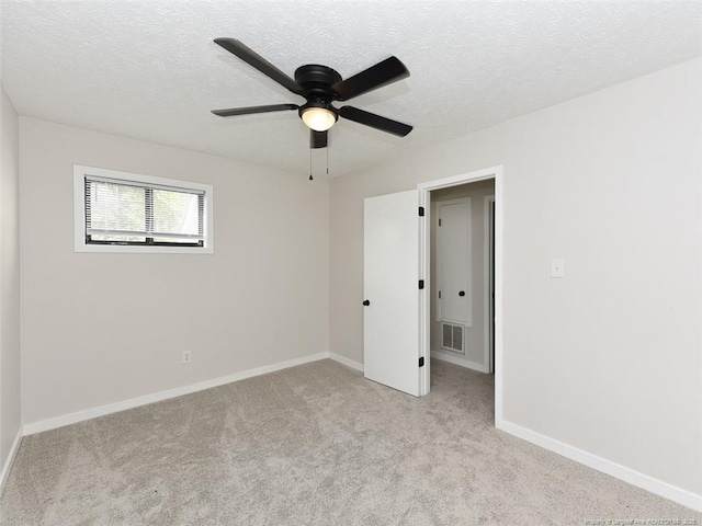 494 Wilder Dr, Fayetteville, NC 28314 - unfurnished bedroom featuring a textured ceiling, light colored carpet, baseboards, and visible vents