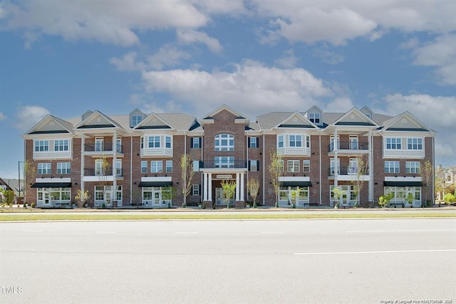 townhome / multi-family property with brick siding