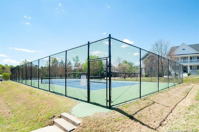 view of tennis court with fence