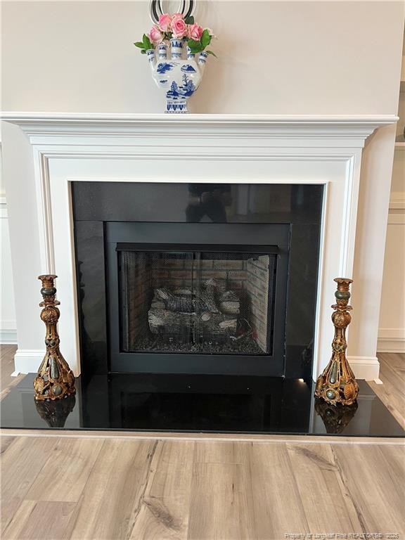details with wood finished floors and a fireplace