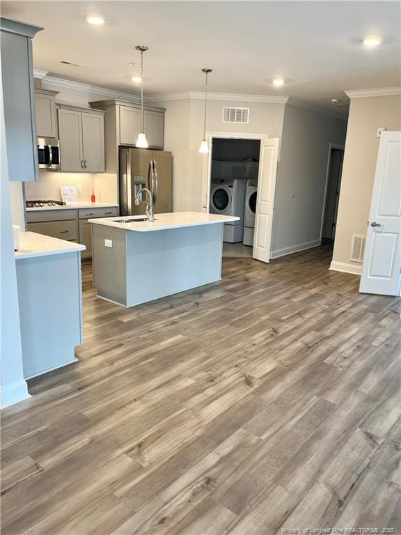 kitchen with crown molding, separate washer and dryer, visible vents, gray cabinets, and appliances with stainless steel finishes