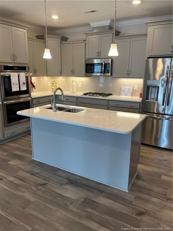 kitchen with stainless steel appliances, gray cabinetry, dark wood-type flooring, and a sink