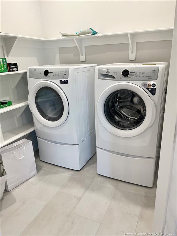 laundry area with separate washer and dryer and laundry area