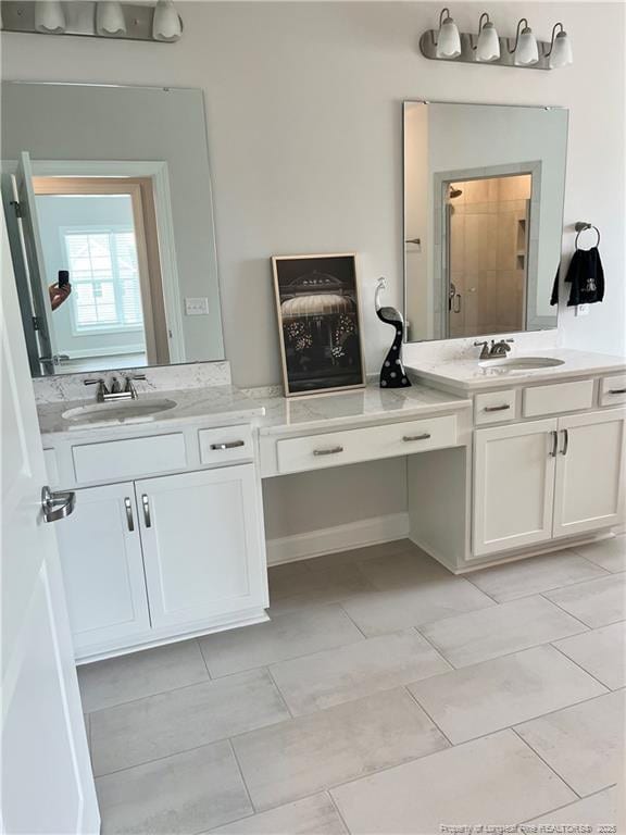 full bathroom with two vanities and a sink