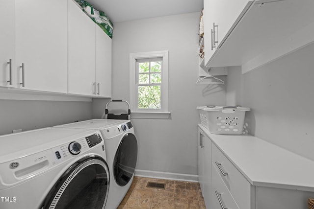 2520 Ashley Ct, Raleigh, NC 27607 - clothes washing area featuring washer and dryer, visible vents, baseboards, and cabinet space
