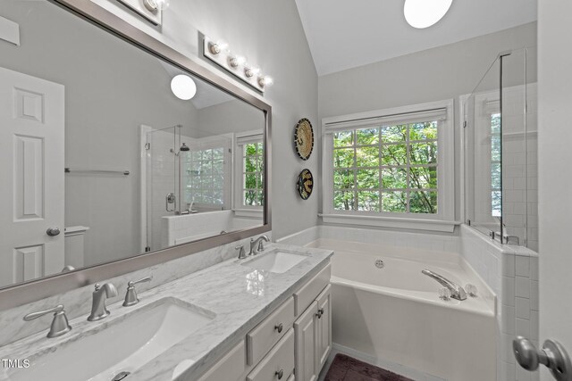 2520 Ashley Ct, Raleigh, NC 27607 - full bath featuring a sink, a stall shower, vaulted ceiling, and a garden tub