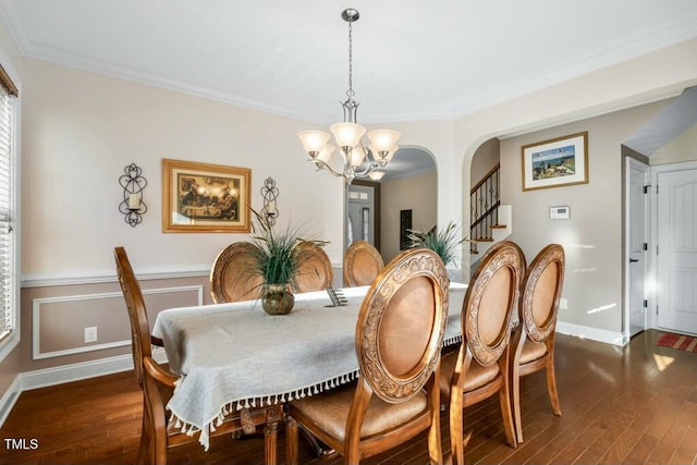 12808 Edsel Dr, Raleigh, NC 27613 - dining room featuring crown molding, an inviting chandelier, wood finished floors, stairs, and baseboards