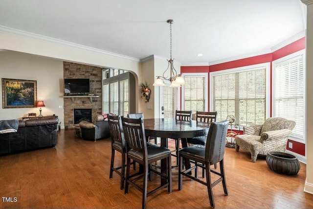 12808 Edsel Dr, Raleigh, NC 27613 - dining space featuring crown molding, an inviting chandelier, and a healthy amount of sunlight