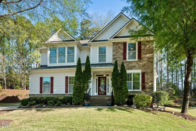 12808 Edsel Dr, Raleigh, NC 27613 - view of front of house featuring a front yard, stone siding, metal roof, and a standing seam roof