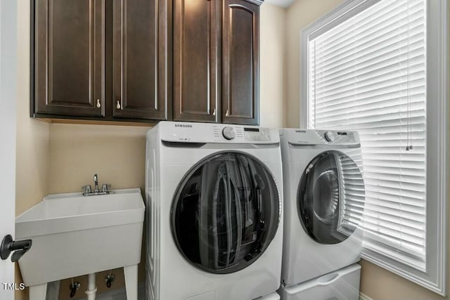 12808 Edsel Dr, Raleigh, NC 27613 - laundry area featuring washer and clothes dryer, a sink, and cabinet space