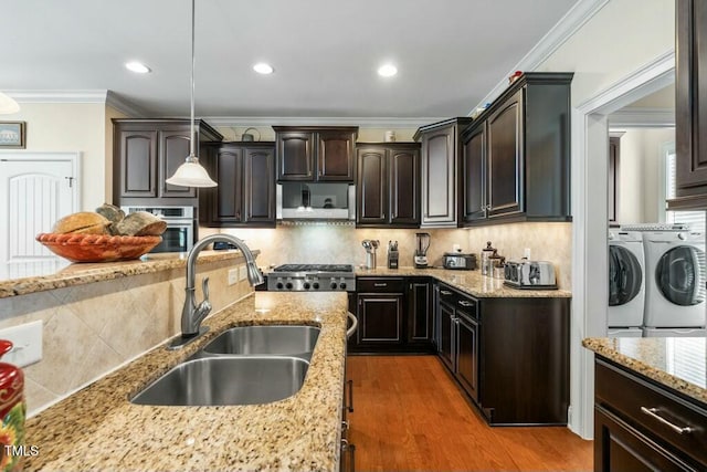 12808 Edsel Dr, Raleigh, NC 27613 - kitchen with separate washer and dryer, a sink, ornamental molding, backsplash, and oven