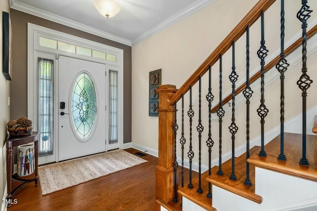 12808 Edsel Dr, Raleigh, NC 27613 - foyer entrance featuring baseboards, ornamental molding, stairway, visible vents, and wood finished floors