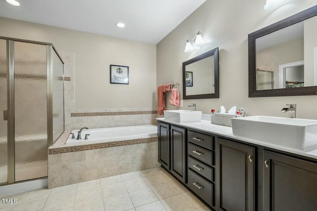 12808 Edsel Dr, Raleigh, NC 27613 - bathroom with a bath, tile patterned flooring, a sink, a stall shower, and double vanity