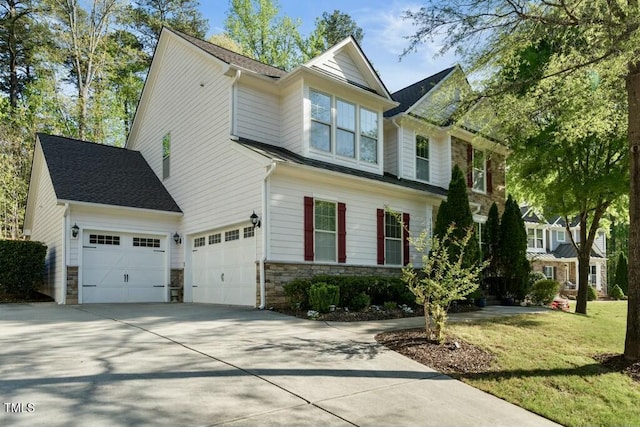 12808 Edsel Dr, Raleigh, NC 27613 - view of front of house with driveway, stone siding, and a front lawn