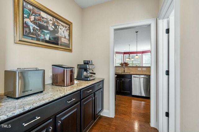 12808 Edsel Dr, Raleigh, NC 27613 - bar featuring dark wood-type flooring, stainless steel dishwasher, and a sink