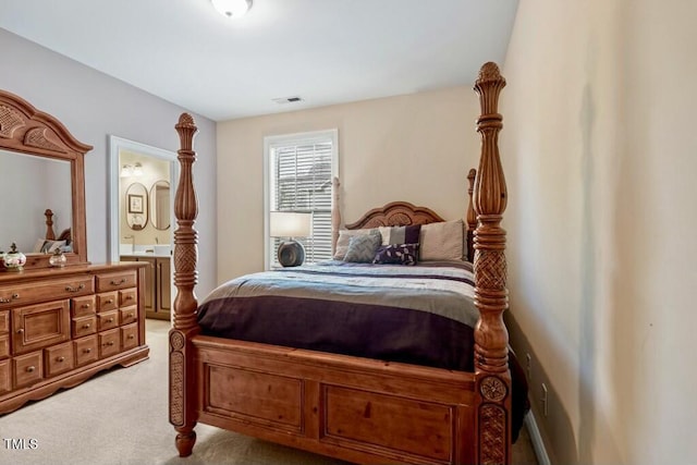 12808 Edsel Dr, Raleigh, NC 27613 - bedroom with light carpet, visible vents, and connected bathroom