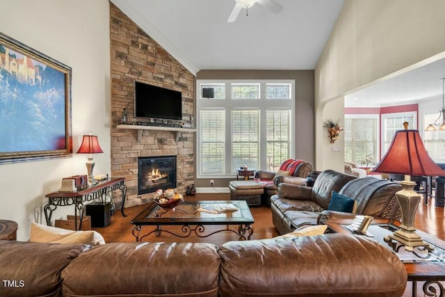 12808 Edsel Dr, Raleigh, NC 27613 - living room with crown molding, ceiling fan, a fireplace, high vaulted ceiling, and wood finished floors