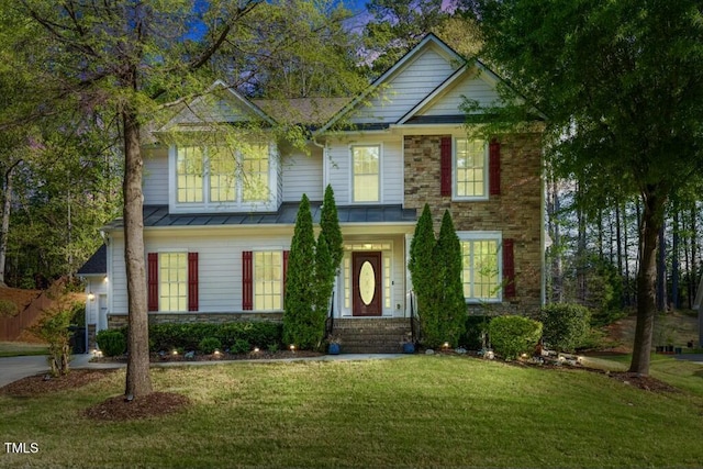 12808 Edsel Dr, Raleigh, NC 27613 - traditional home featuring a standing seam roof, metal roof, stone siding, and a front lawn