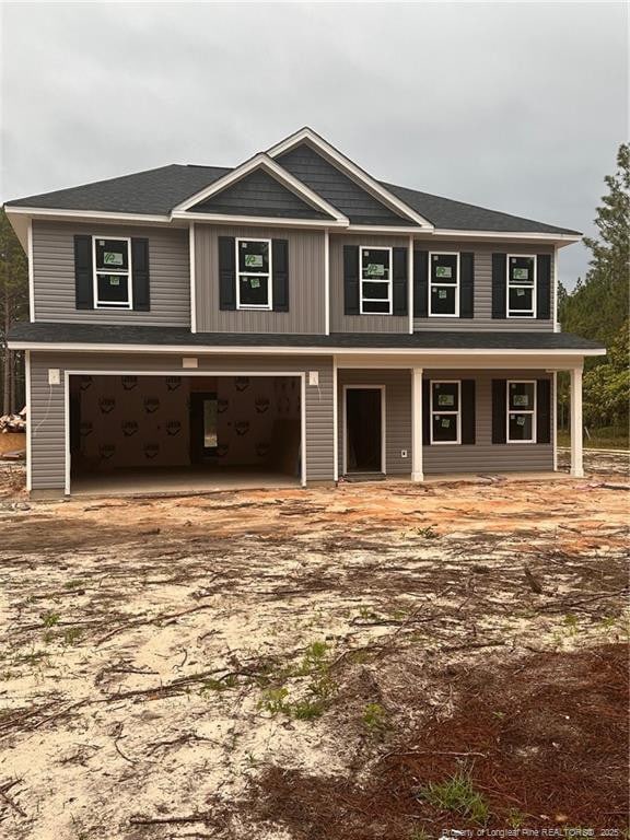 161 Merle Rd, Pinebluff, NC 28373 - view of front of house featuring driveway, an attached garage, and a porch
