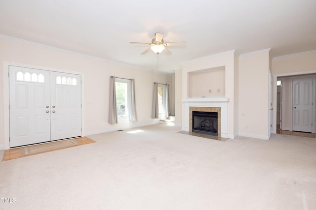 627 Carraway Dr, Graham, NC 27253 - unfurnished living room with baseboards, light colored carpet, a ceiling fan, and crown molding