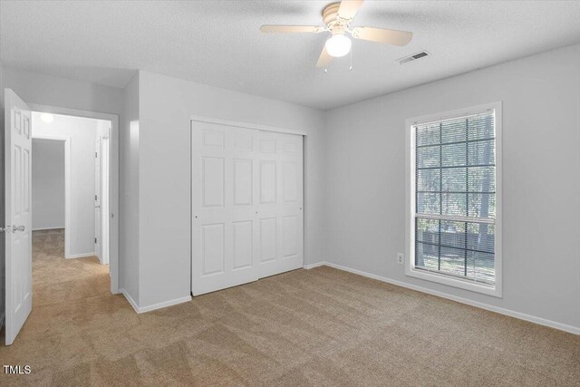 1517 Laughridge Dr, Cary, NC 27511 - unfurnished bedroom with carpet, a closet, baseboards, a textured ceiling, and ceiling fan